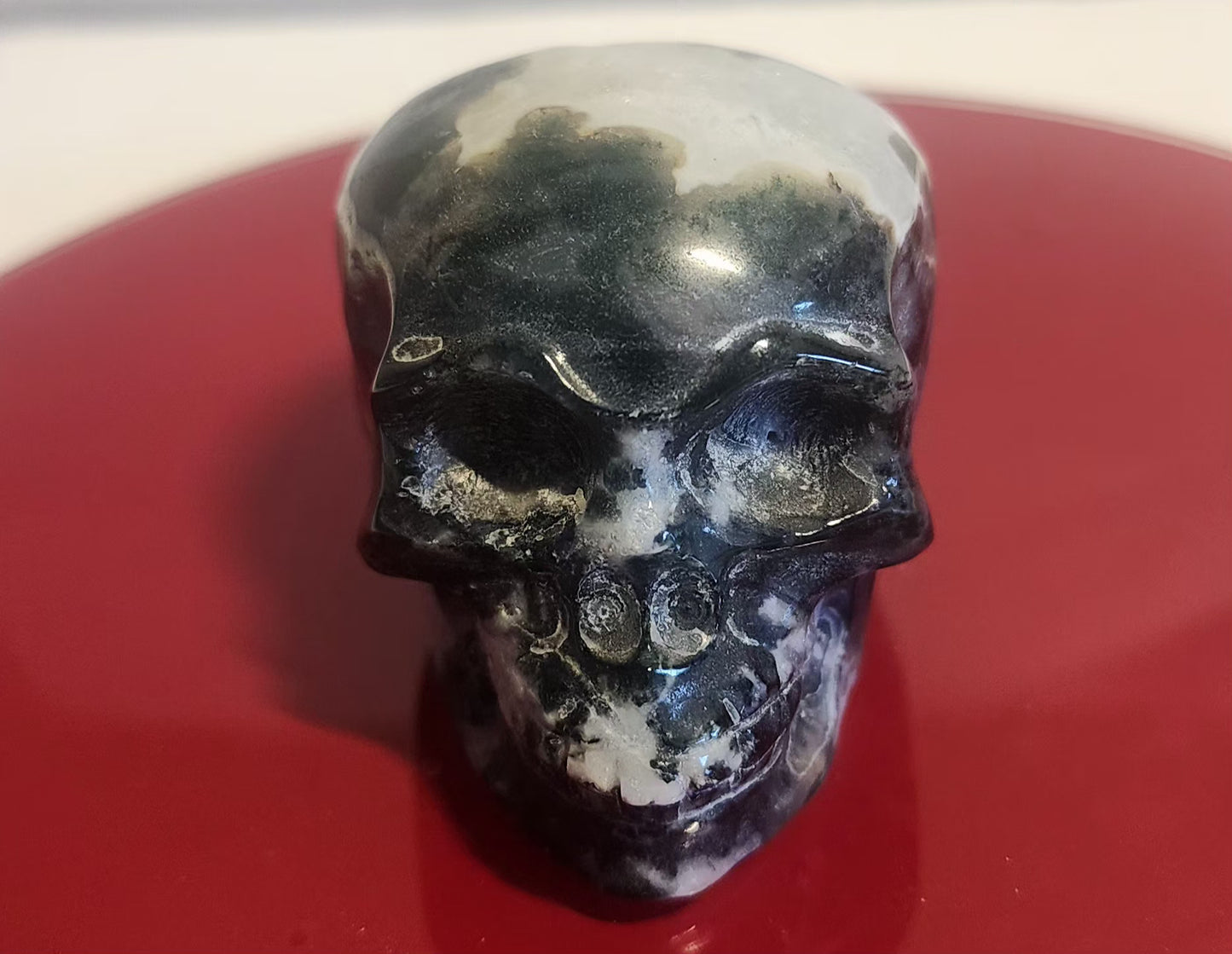Moss agate skull carvings