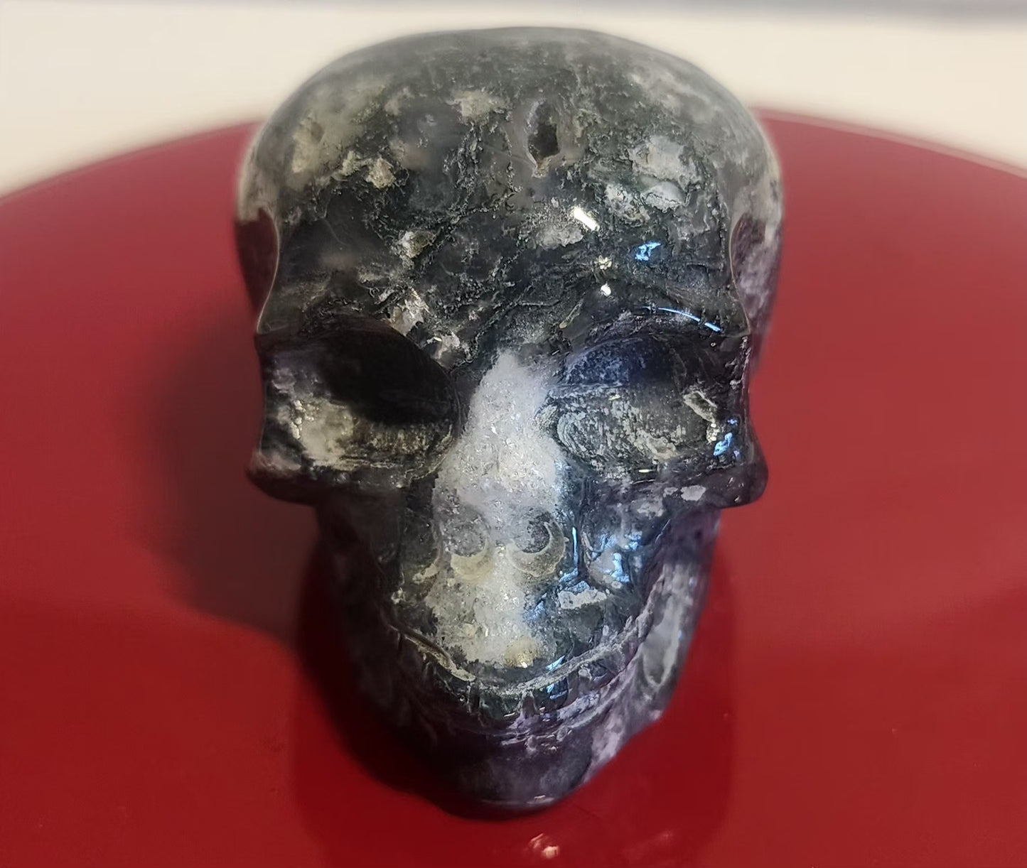 Moss agate skull carvings